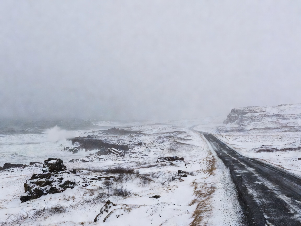 Low winter cloud over an exposed Icelandic coastal road